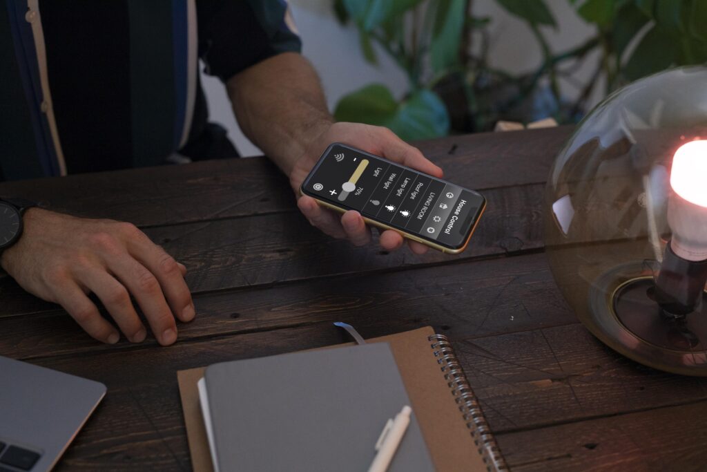 man-controlling-smart-lamp-with-his-phone